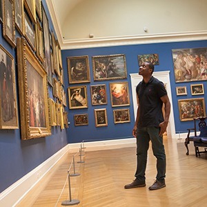person looking at paintings